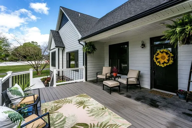 a view of a patio with couches table and chairs and potted plants