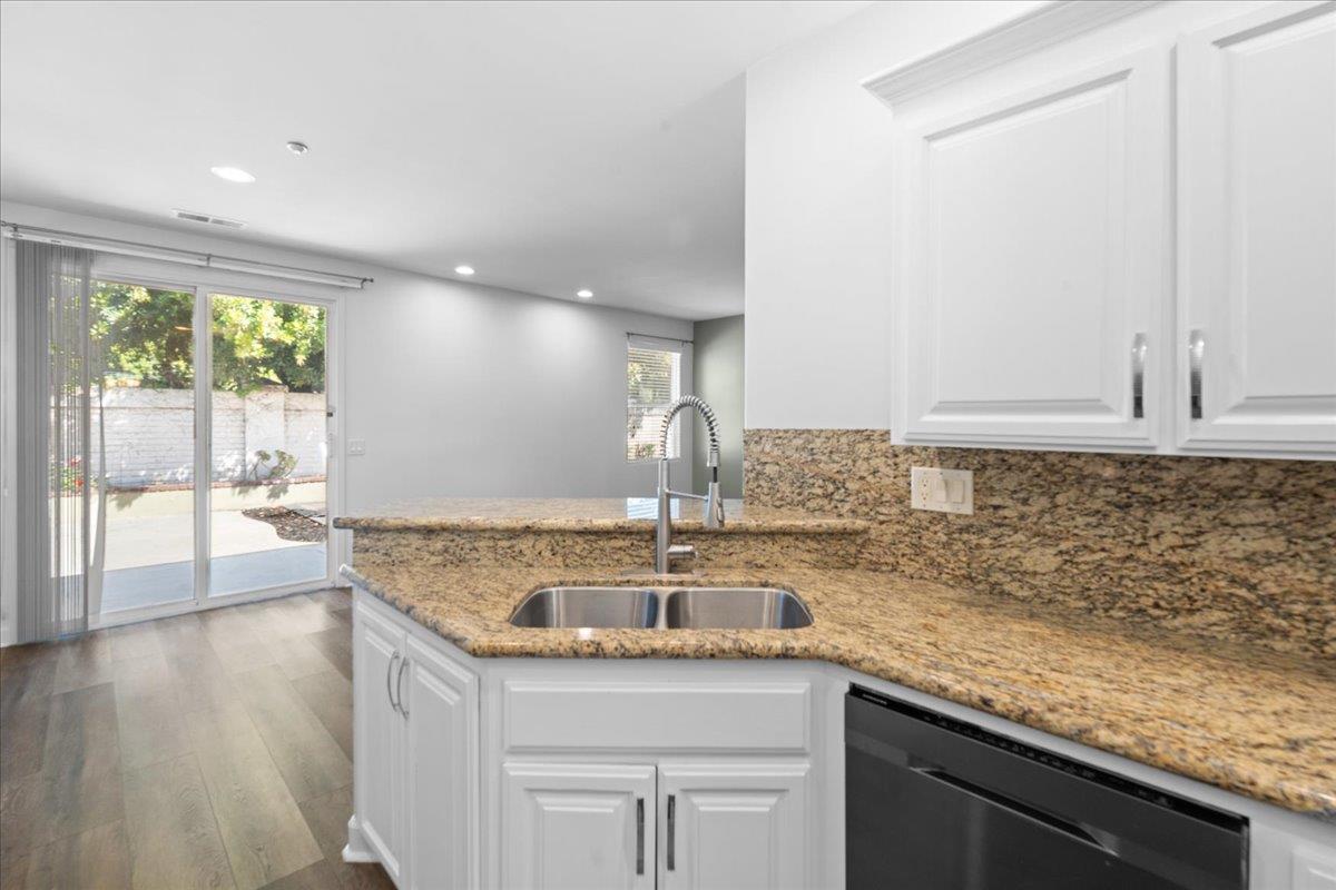 478 Churchill Way Salinas, CA 93906 - Photo 8 of 31 a kitchen with sink cabinets and wooden floor