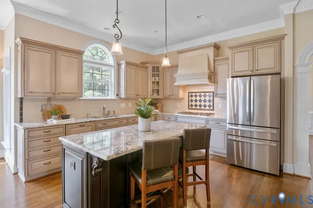 a kitchen with stainless steel appliances granite countertop a sink a stove and cabinets