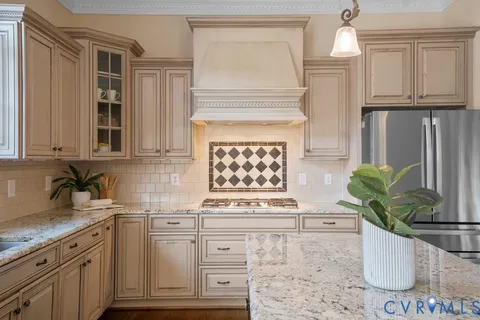 a kitchen with stainless steel appliances granite countertop a kitchen island a stove and a sink