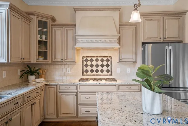 a kitchen with stainless steel appliances granite countertop a kitchen island a stove and a sink