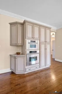 a kitchen with a table chairs stove and granite counter top