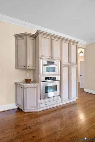 a kitchen with a table chairs stove and granite counter top