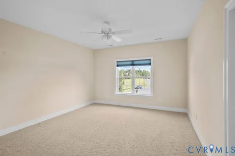 a view of an empty room with a ceiling fan
