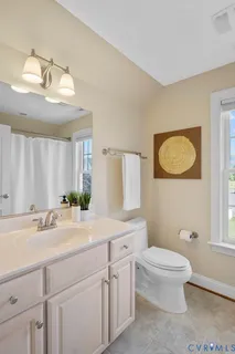 an empty room with a window and a ceiling fan