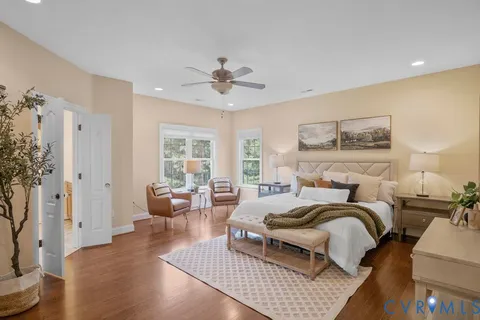 a spacious bedroom with a bed and a dresser