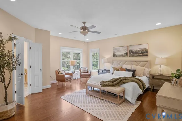 a spacious bedroom with a bed and a dresser