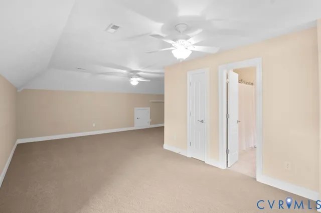 an empty room with fan and a ceiling fan