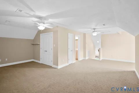 an empty room with a ceiling fan and a window