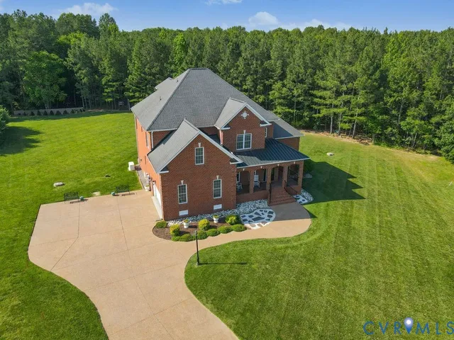 an aerial view of a house with a yard basket ball court and outdoor seating