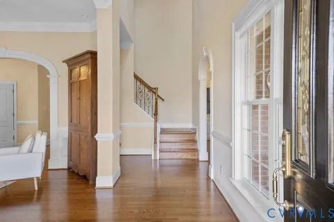 a view of an entryway with wooden floor