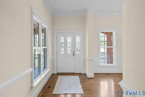 a living room with furniture a table and paintings on the wall