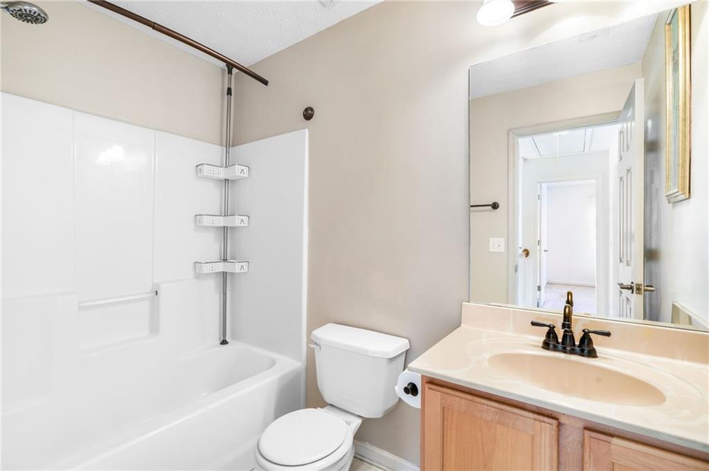 562 Windcroft Circle Northwest Acworth, GA 30101 - Photo 15 of 25 a bathroom with a sink a toilet and a large mirror