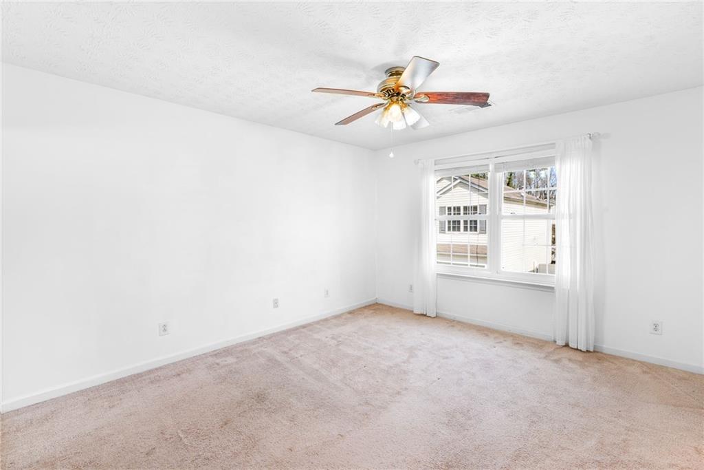 562 Windcroft Circle Northwest Acworth, GA 30101 - Photo 19 of 25 an empty room with windows and fan