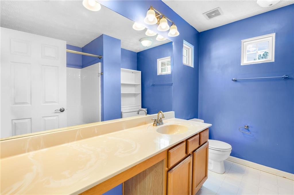 562 Windcroft Circle Northwest Acworth, GA 30101 - Photo 20 of 25 a bathroom with a sink a toilet and a mirror