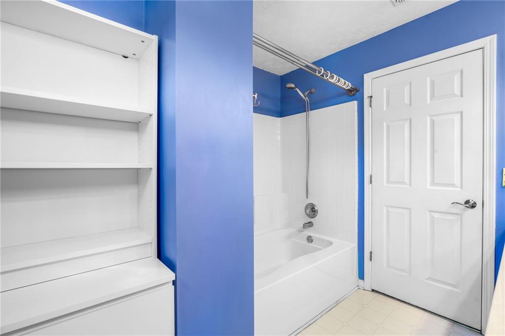 562 Windcroft Circle Northwest Acworth, GA 30101 - Photo 21 of 25 a bathroom with a bathtub and a shower