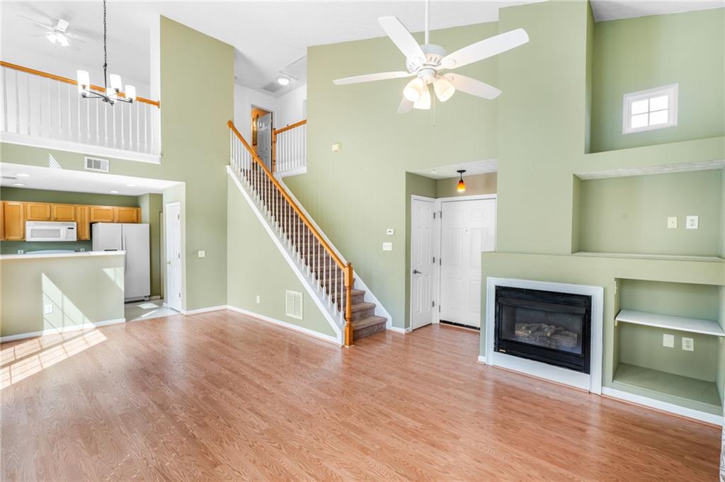 562 Windcroft Circle Northwest Acworth, GA 30101 - Photo 4 of 25 a view of a livingroom with furniture wooden floor staircase and a kitchen
