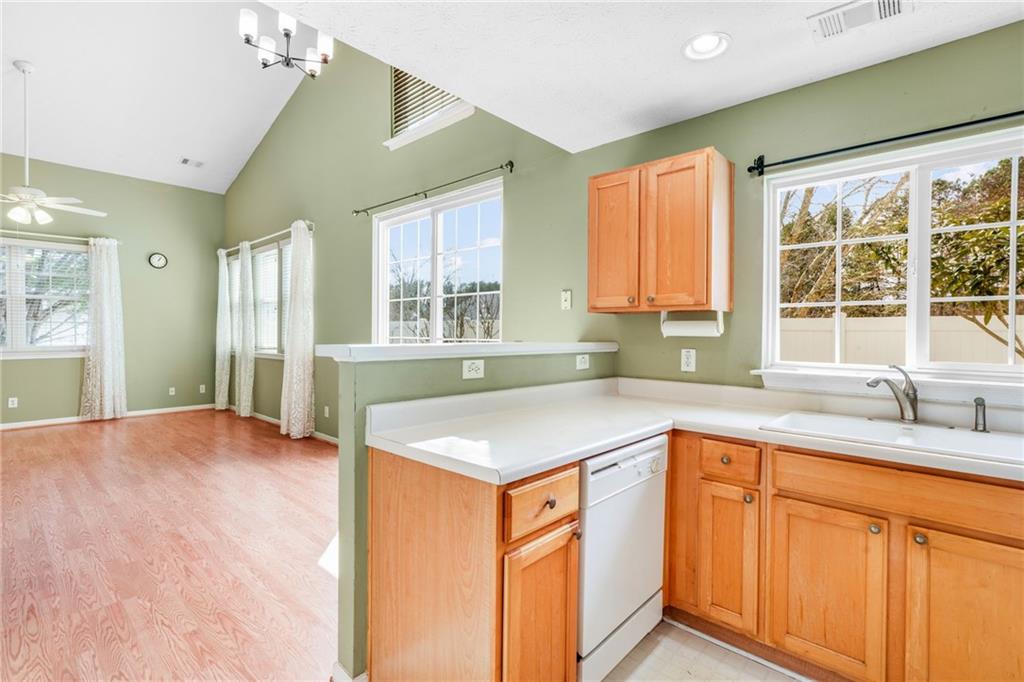 562 Windcroft Circle Northwest Acworth, GA 30101 - Photo 7 of 25 a kitchen with stainless steel appliances granite countertop a sink and a granite counter tops with a large window