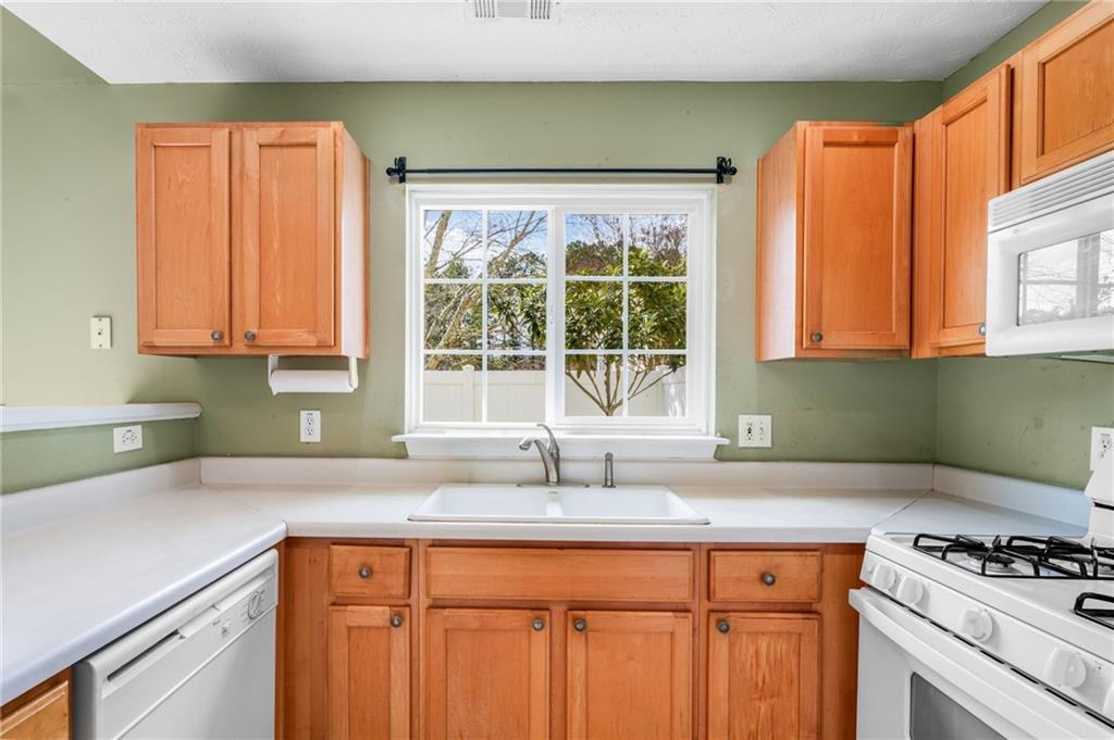 562 Windcroft Circle Northwest Acworth, GA 30101 - Photo 8 of 25 a kitchen with stainless steel appliances a sink a stove and a window