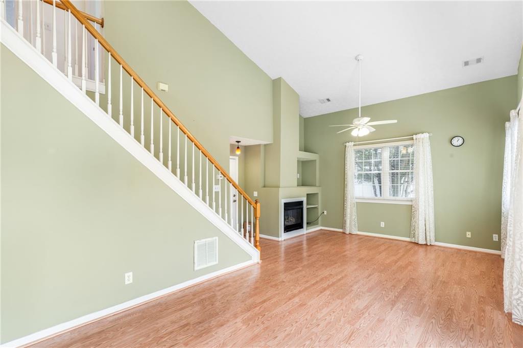 562 Windcroft Circle Northwest Acworth, GA 30101 - Photo 9 of 25 a view of an empty room with wooden floor and a window