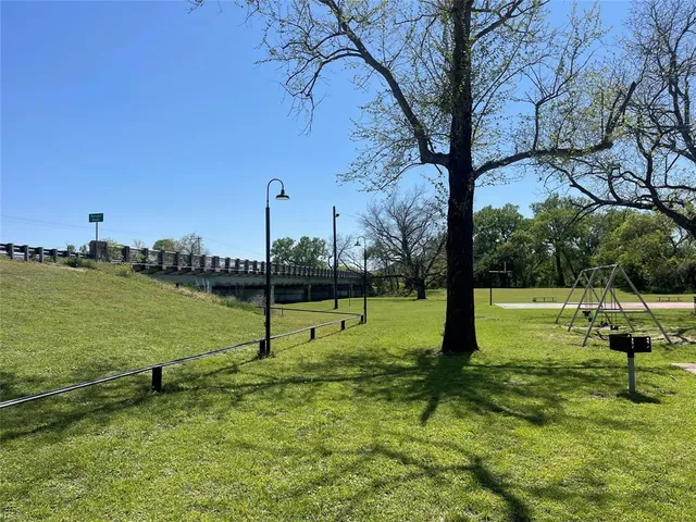 a view of a park with large trees