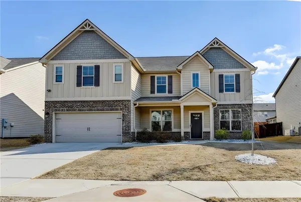 a front view of a house with a yard