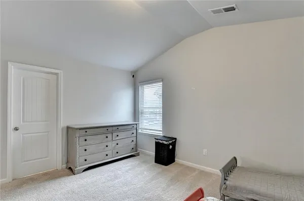 a view of an empty room with windows