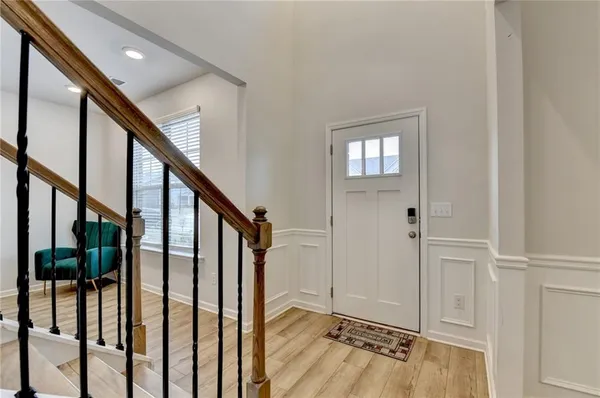 a view of an entryway with wooden floor and door