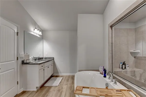 a bathroom with a granite countertop sink and a large mirror