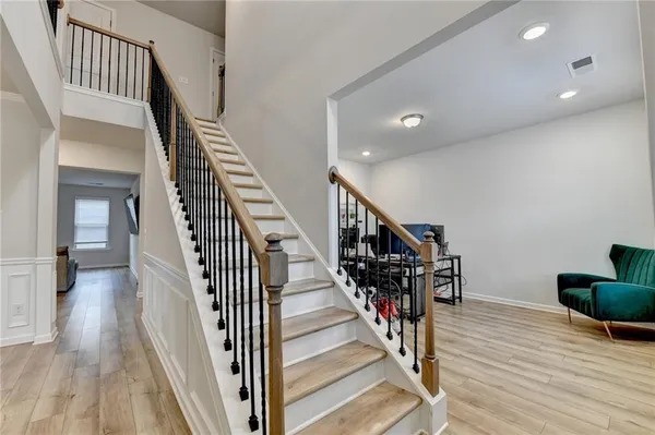 a view of entryway and hall with wooden floor