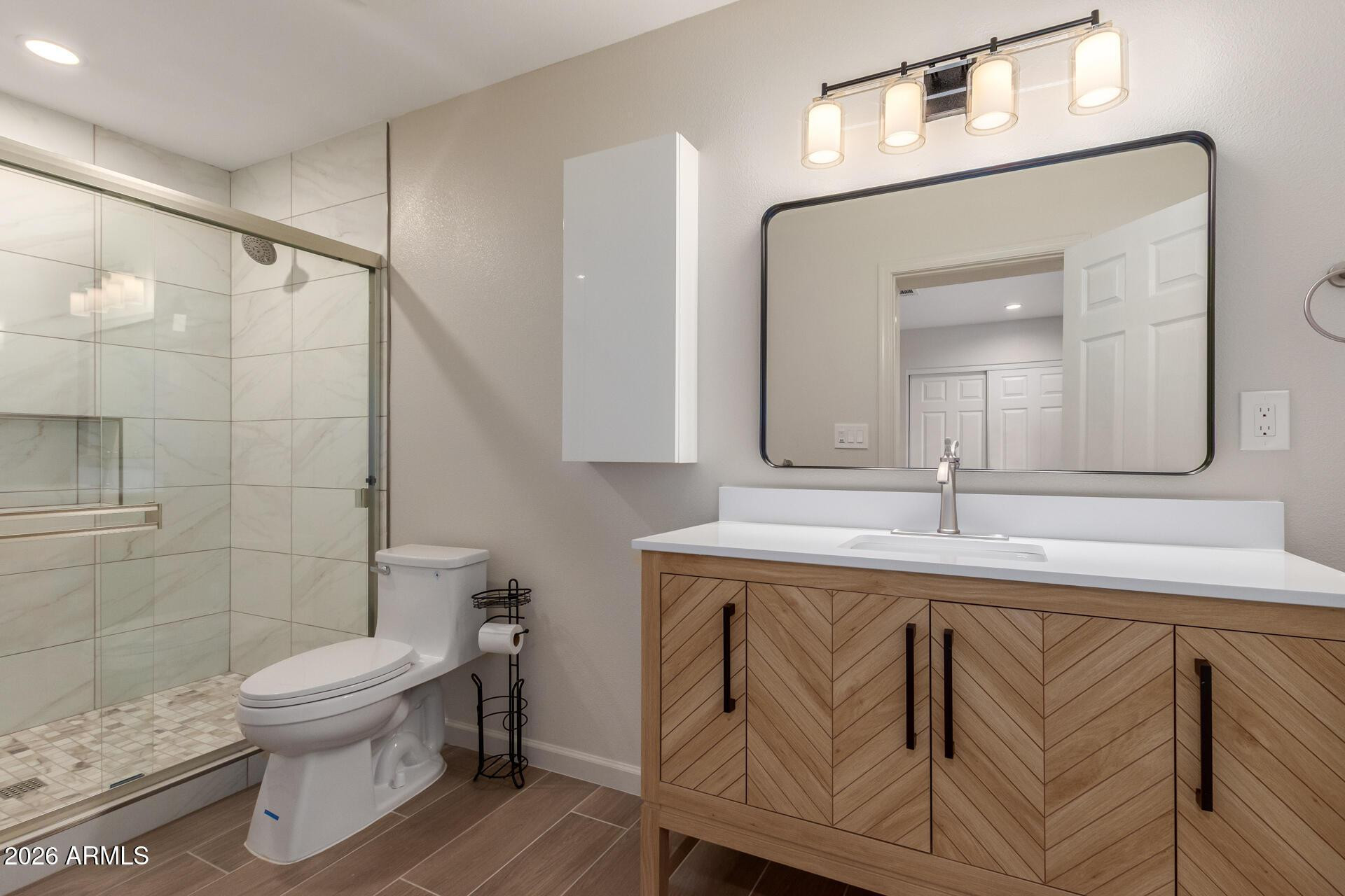 1628 East Del Rio Drive Tempe, AZ 85282 - Photo 19 of 32 a bathroom with a toilet a sink and mirror
