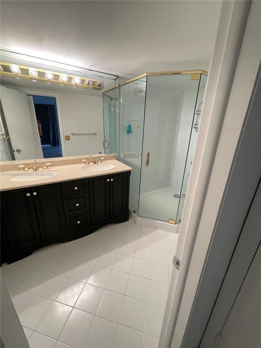 9001 Southwest 94th Street, Unit 201 Miami, FL 33176 - Photo 7 of 10 a bathroom with a sink vanity granite tub and shower
