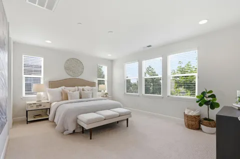 a bedroom with a bed couch and window