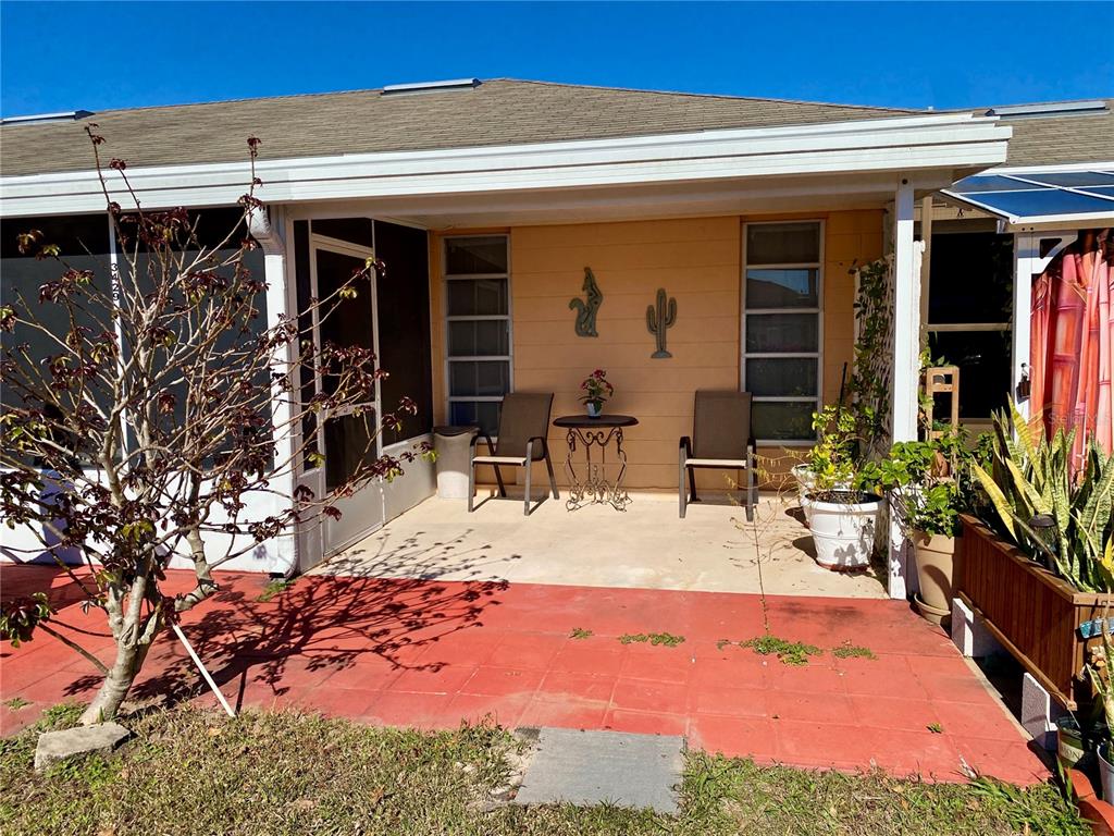 3429 Club Circle Lakeshore, FL 33854 - Photo 15 of 37 a view of a patio with table and chairs potted plants and floor to ceiling window