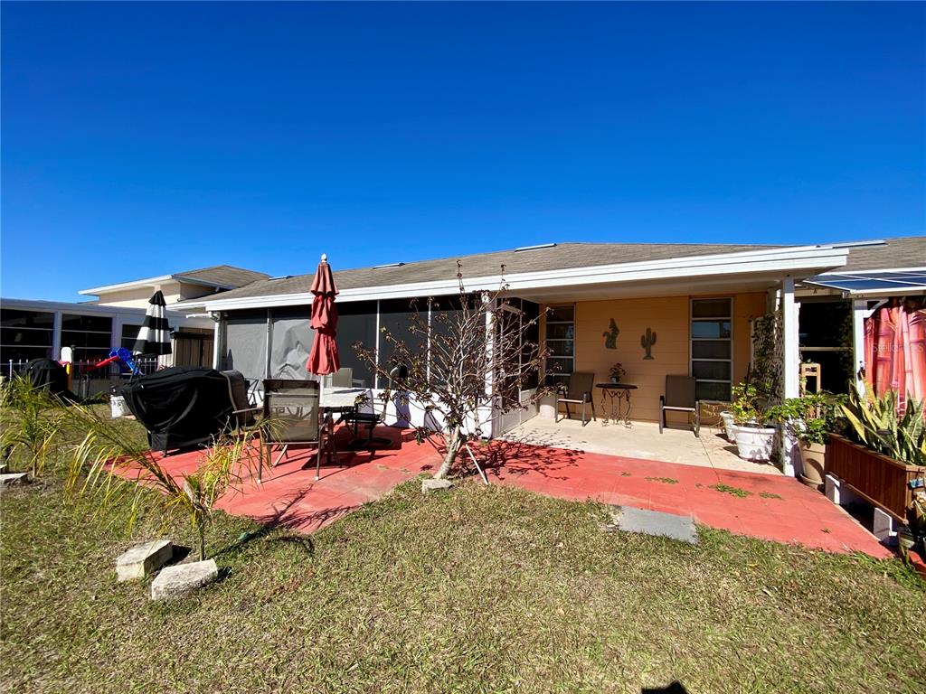 3429 Club Circle Lakeshore, FL 33854 - Photo 16 of 37 a view of a patio with table and chairs under an umbrella