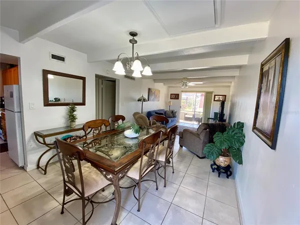 a view of a dining room with furniture and a chandelier