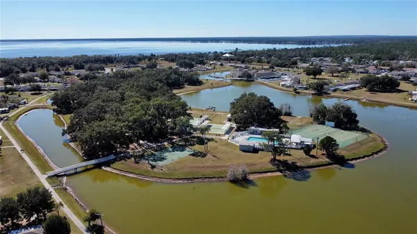 an aerial view of a house with a swimming pool yard and outdoor seating