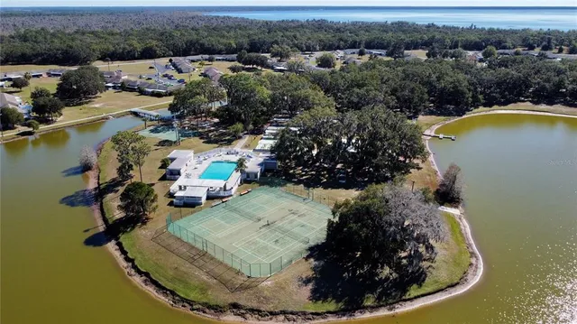 an aerial view of residential houses with outdoor space and parking