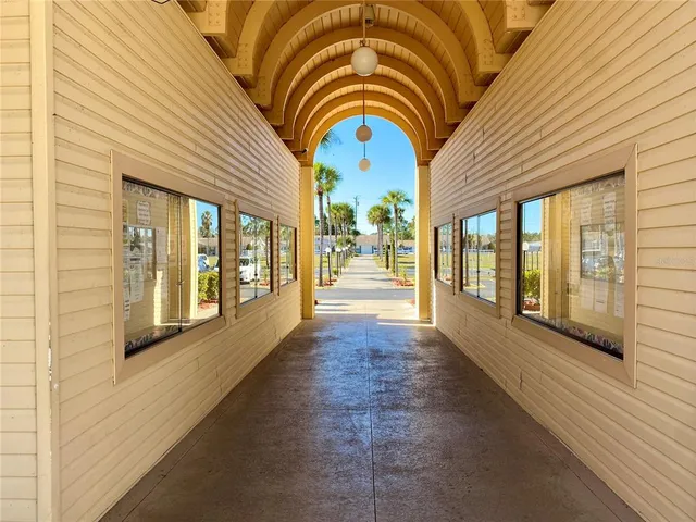 a view of a patio with a table and chairs and potted plants