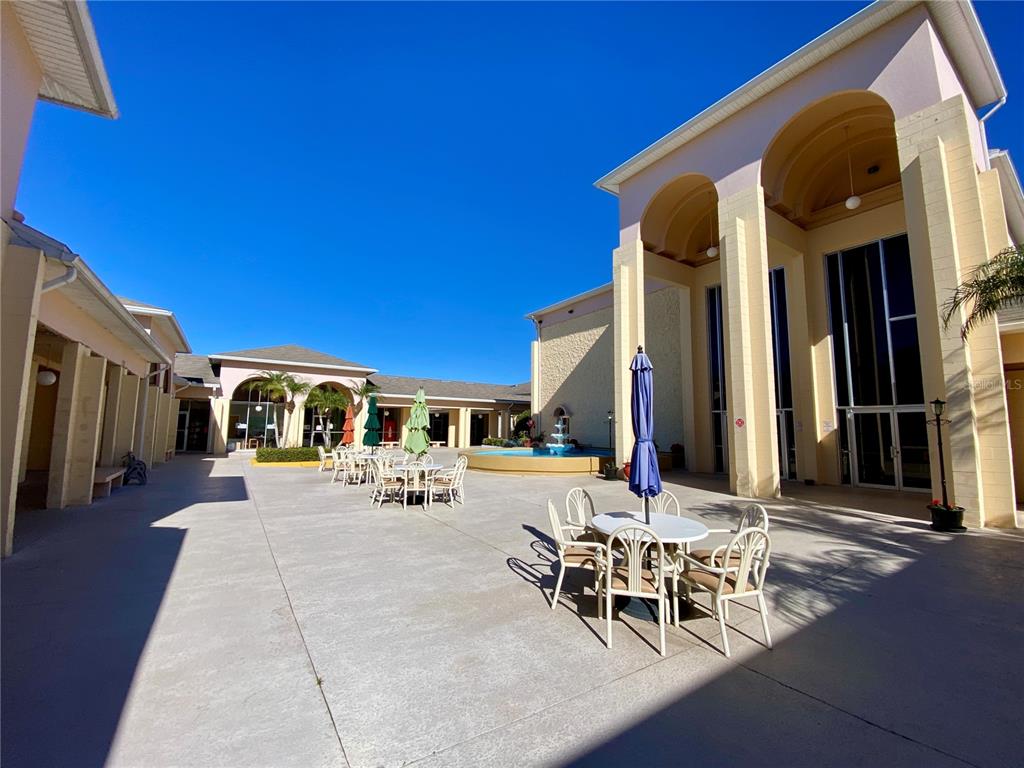 3429 Club Circle Lakeshore, FL 33854 - Photo 28 of 37 a view of a patio with a table and chairs and potted plants