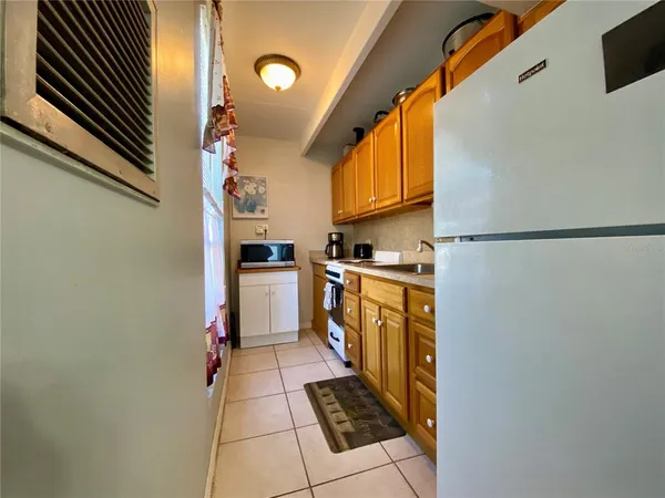 a kitchen with stainless steel appliances a refrigerator and a stove top oven