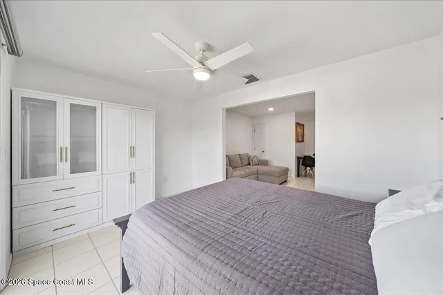 a bedroom with a bed and a mirror