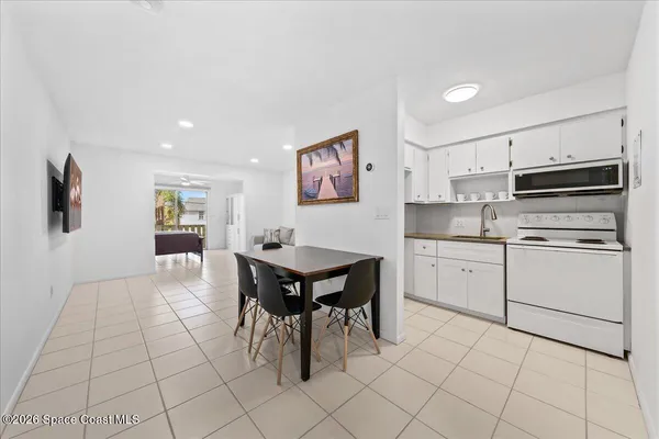 a kitchen with cabinets and chairs