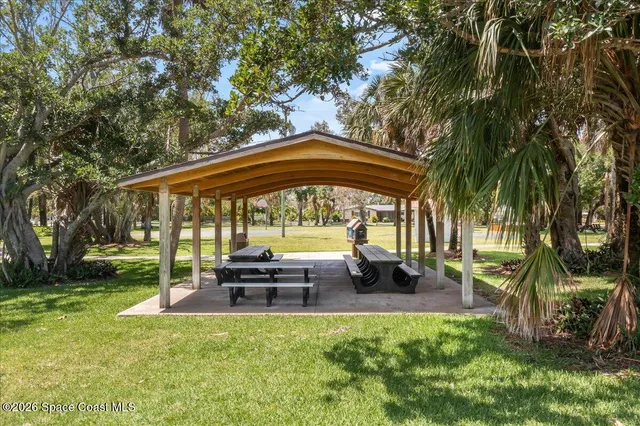 a view of a house with backyard porch and sitting area