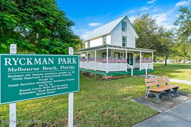 a view of a chair and table in backyard of the house