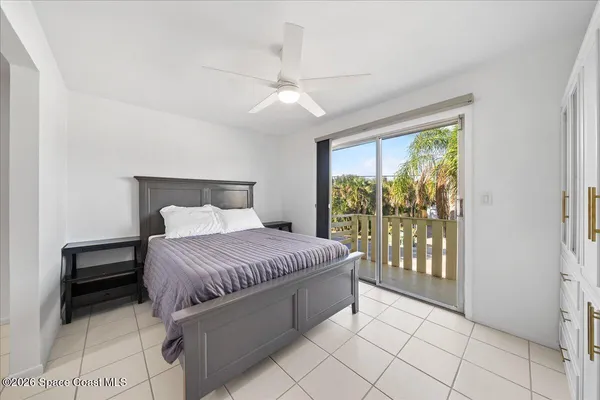a spacious bedroom with a bed and a large window