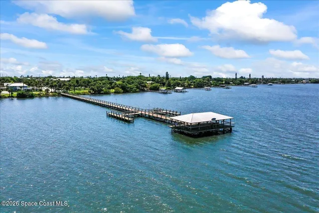 a view of a lake with houses in back