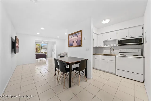 a kitchen with cabinets and chairs