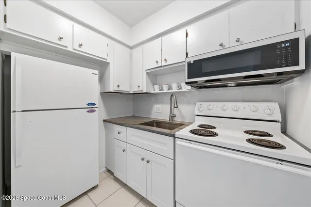 a kitchen with appliances a microwave and cabinets
