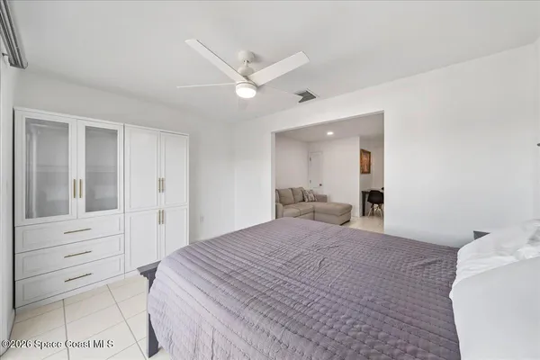 a bedroom with a bed and a mirror